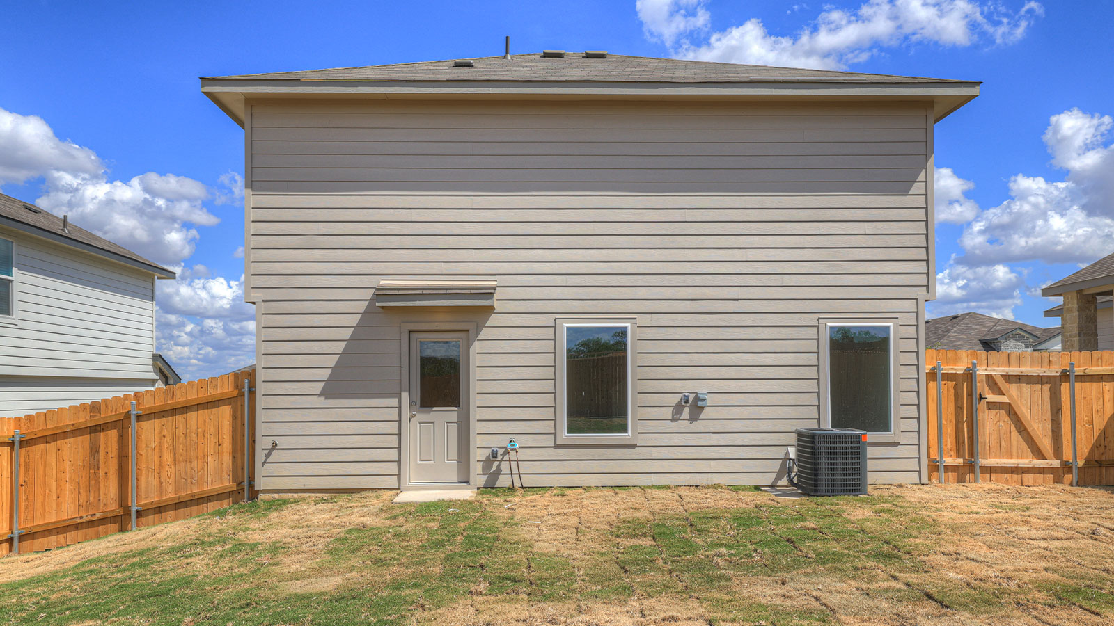 Backyard with sod and privacy fence.