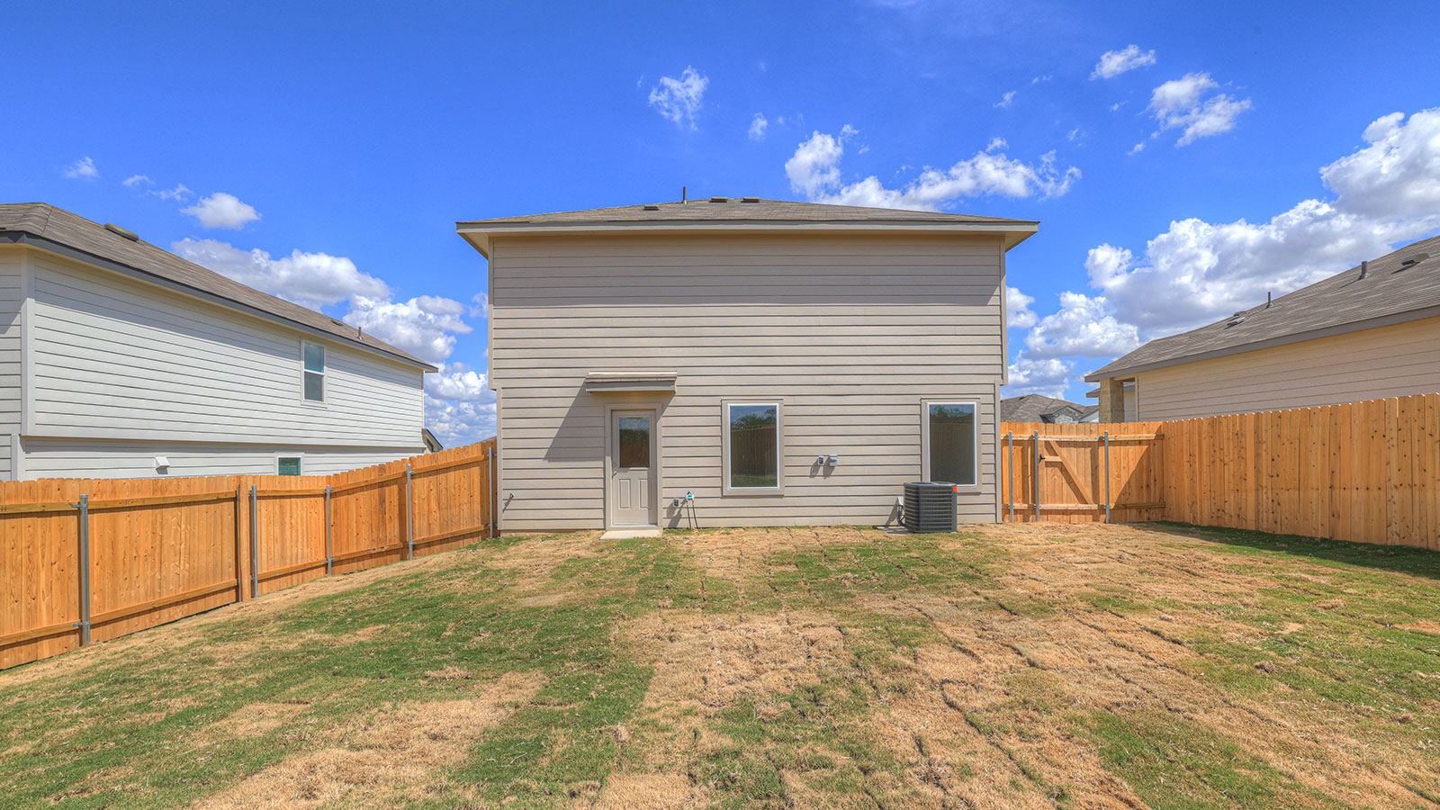 Backyard with sod and privacy fence.
