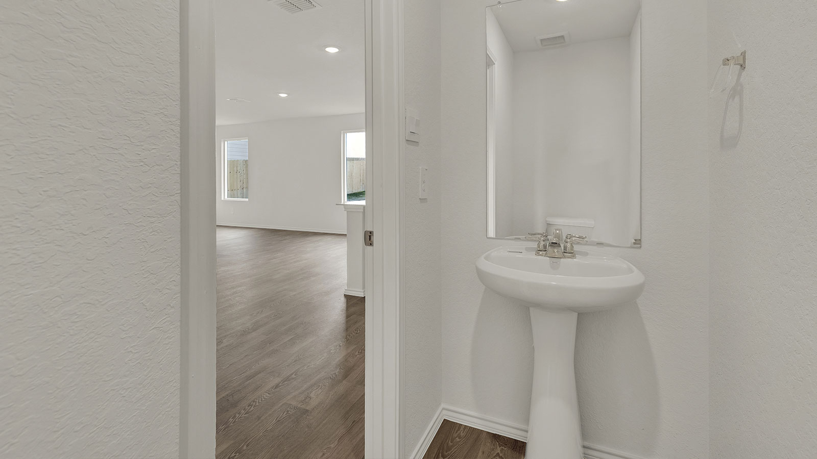 Powder room with pedestal sink.