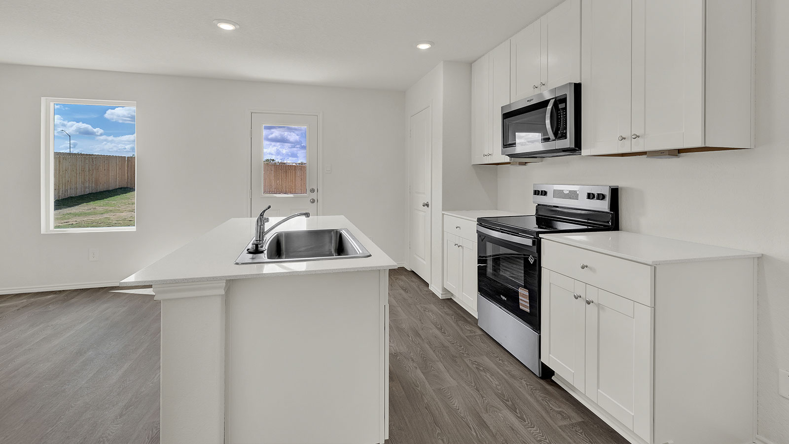 Kitchen with white cabinets and stainless steel cabinets.