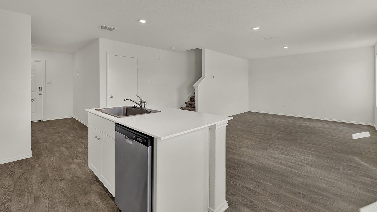 Kitchen with kitchen island and stainless steel sink.