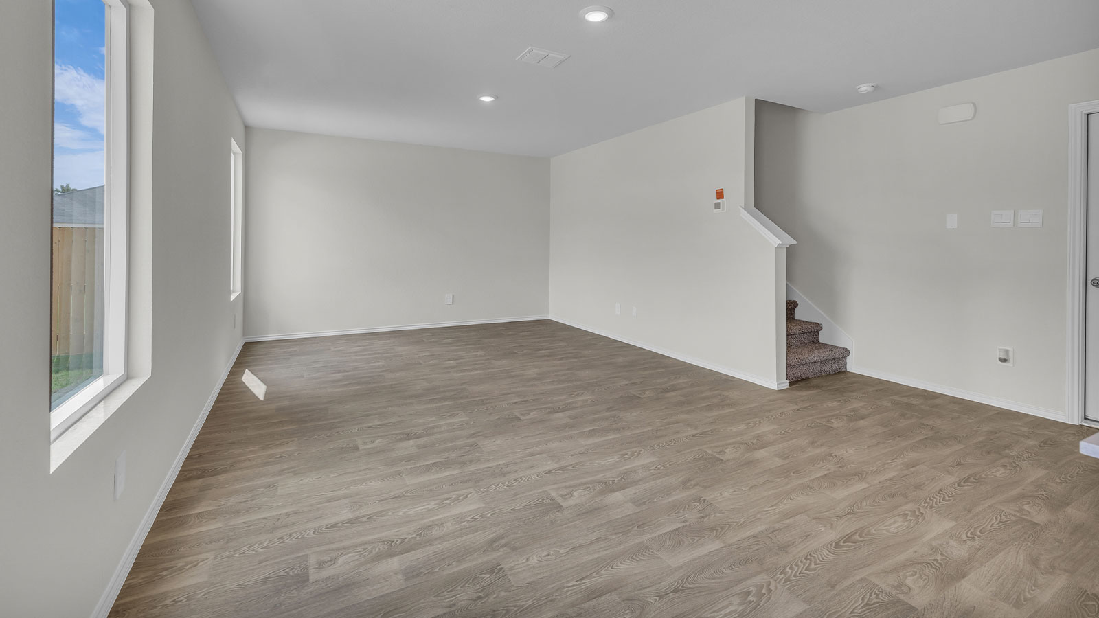 Dining room with vinyl flooring opening to the kitchen.