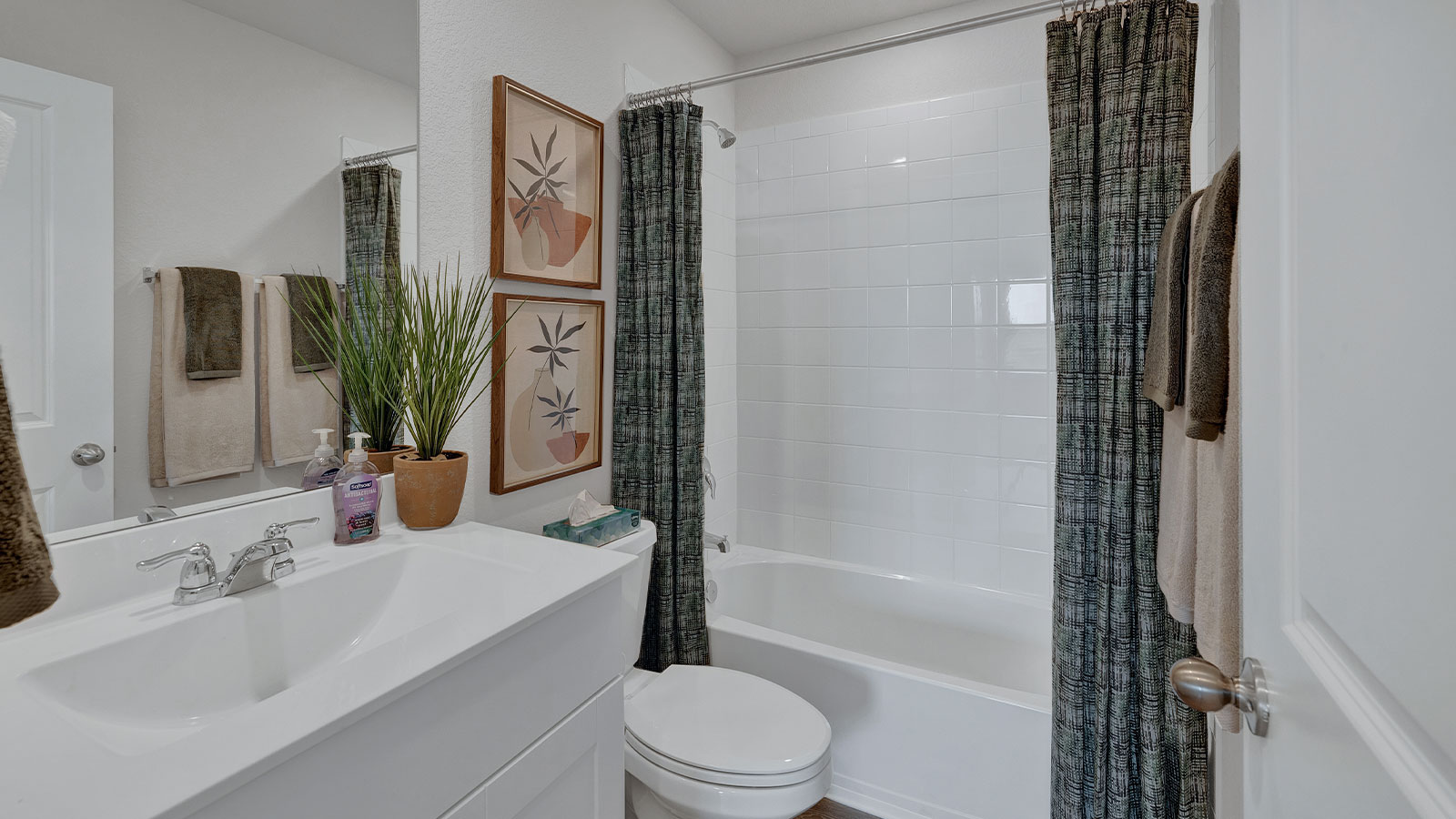 Hall bathroom with single-sink vanity, toilet, and tub.