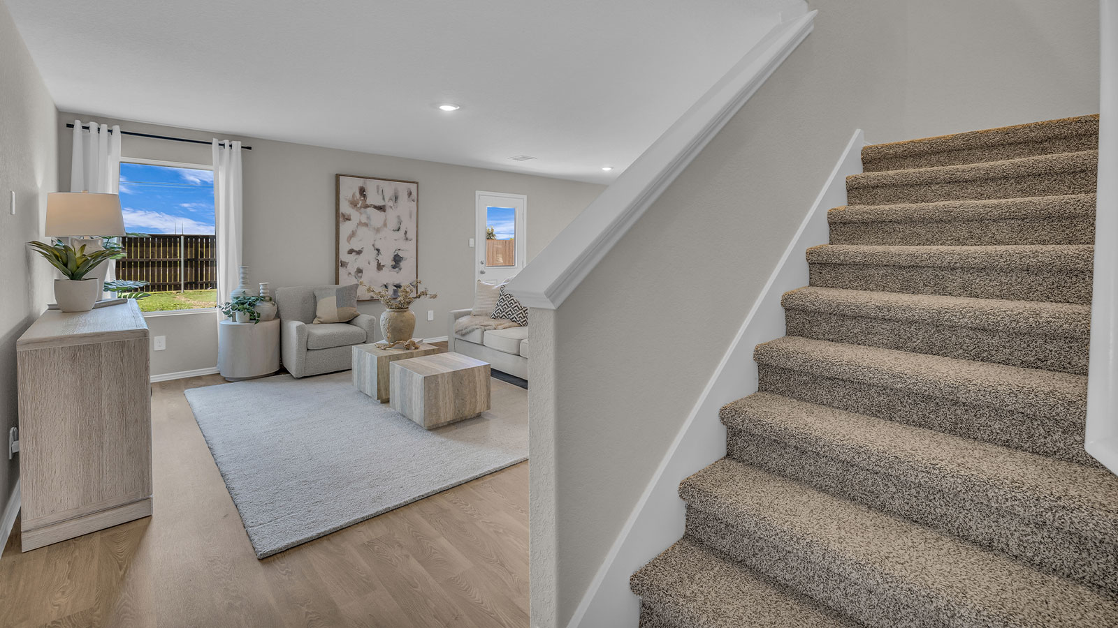 Entry hallway showing staircase and entering the living room.