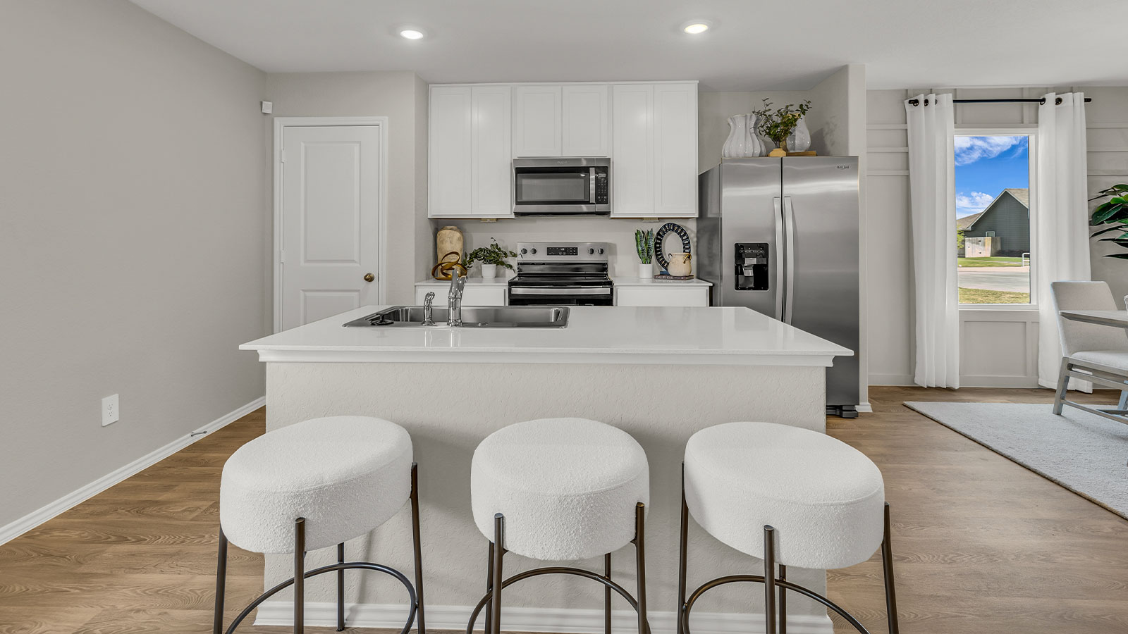 Kitchen with kitchen island and white cabinets.