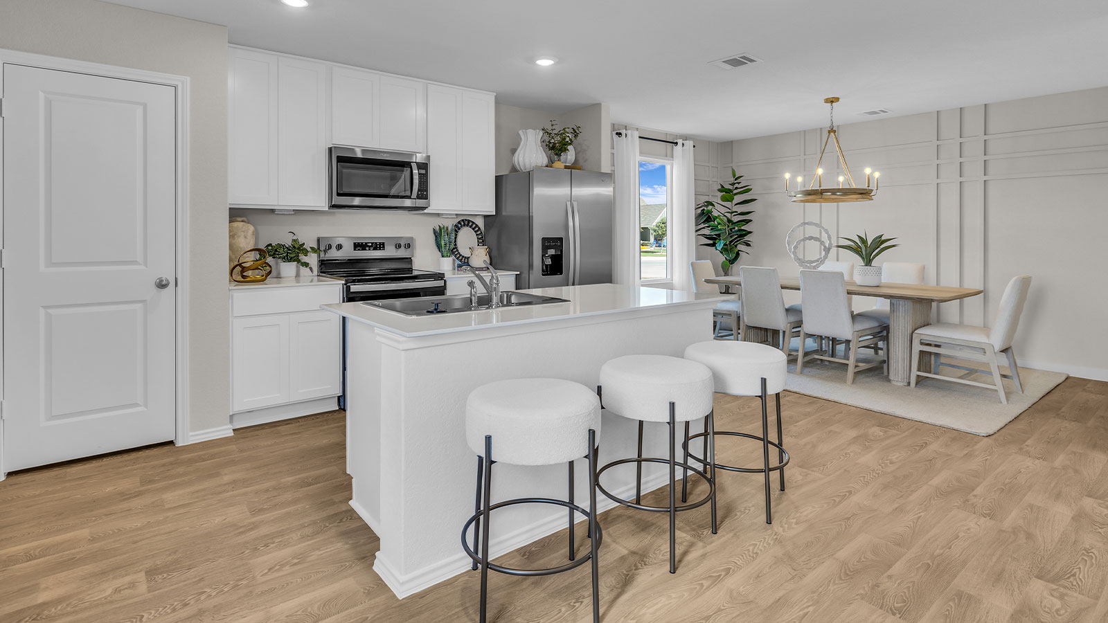 Kitchen with kitchen island and stainless steel appliances.