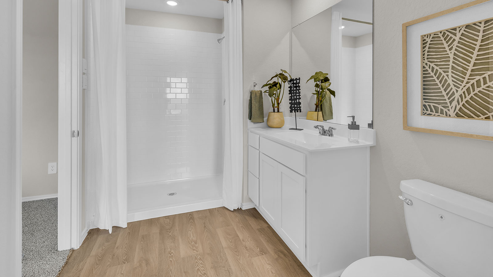 Main bathroom with sink, toilet, and shower.