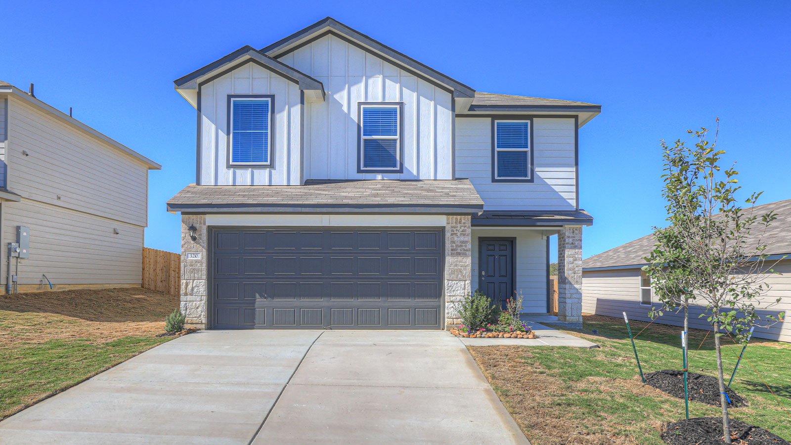Two-story masonry exterior photo with 2 car garage.