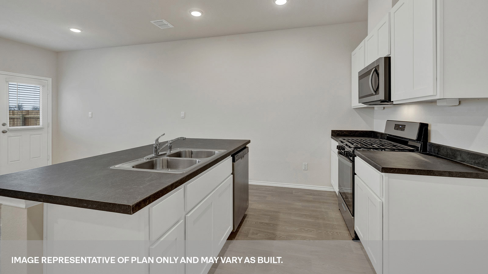 Kitchen with kitchen island and white cabinets.