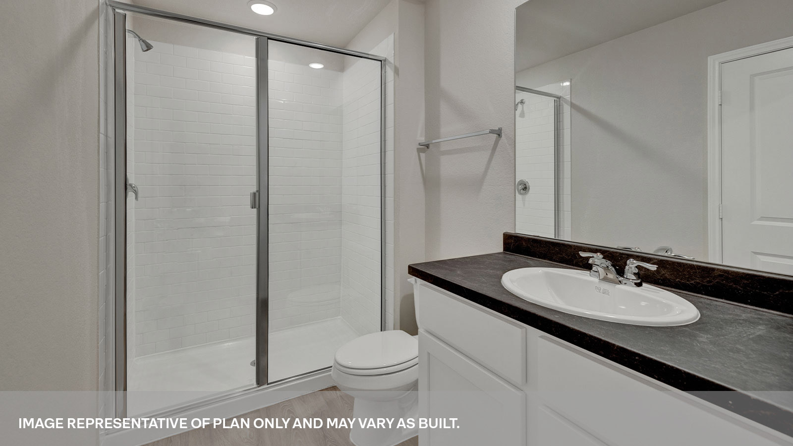 Main bathroom with large walk-in shower with glass door, toilet and a single sink vanity.