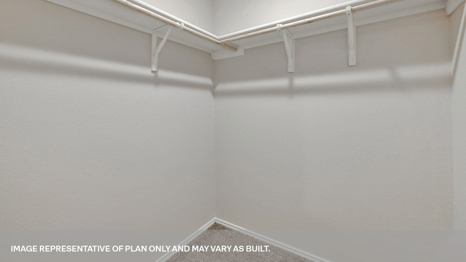 Large walk-in closet with wooden shelves.