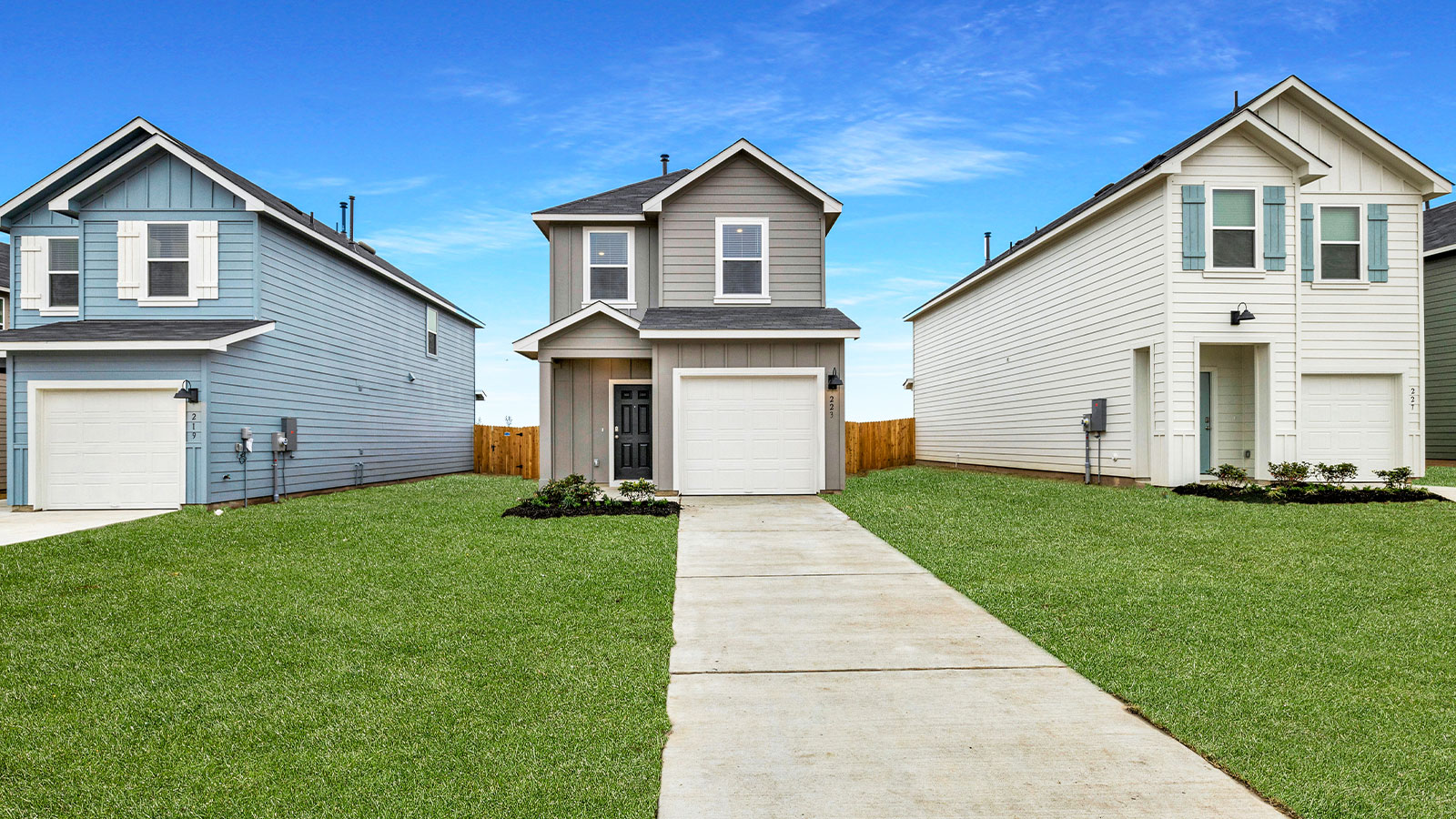 Two-story farmhouse exterior with two windows and 1 car garage.