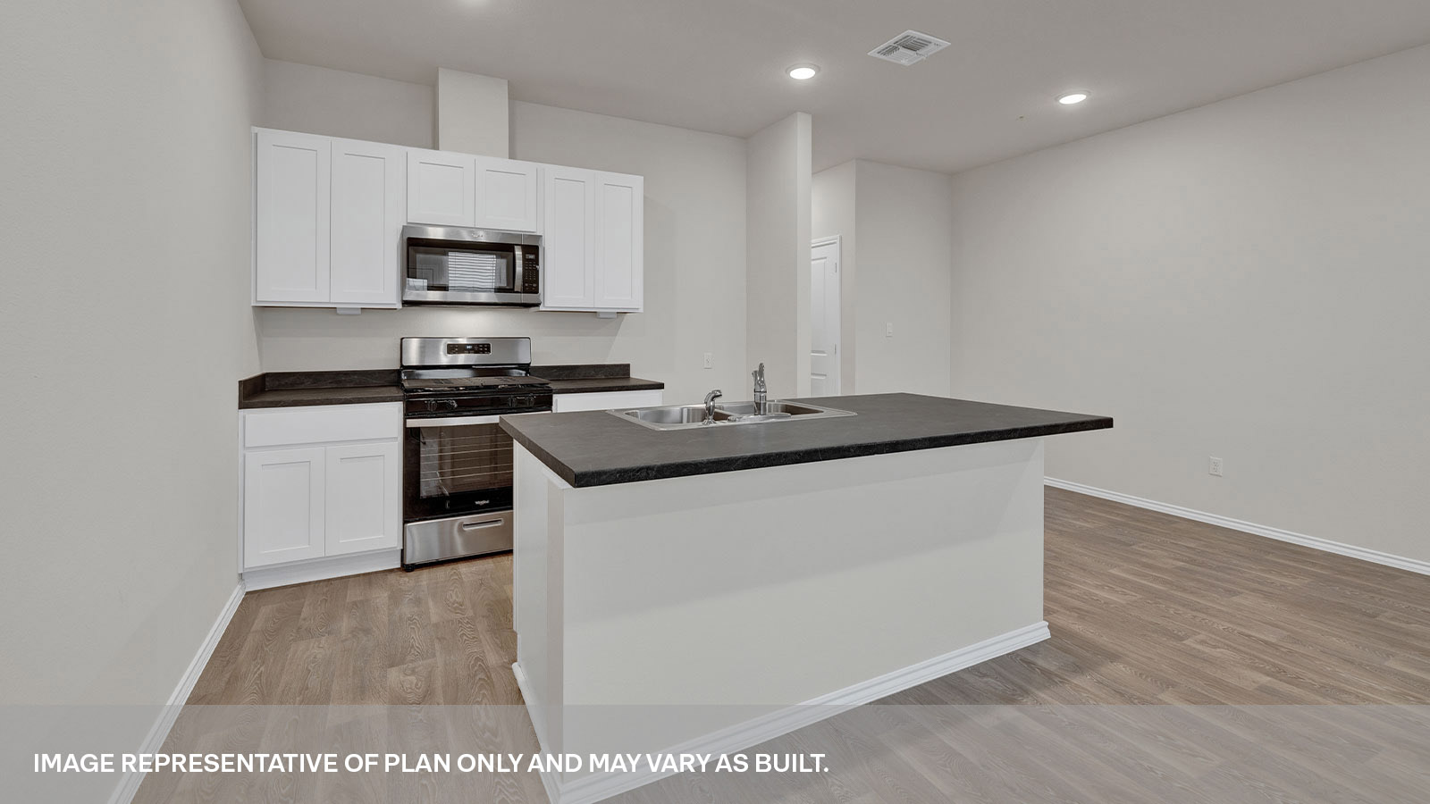 Kitchen island overlooking the living room, 3 windows and backdoor with a half-lite window.