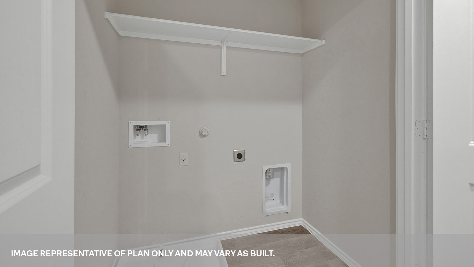 Laundry room with a wood shelf and washer/dryer connections.