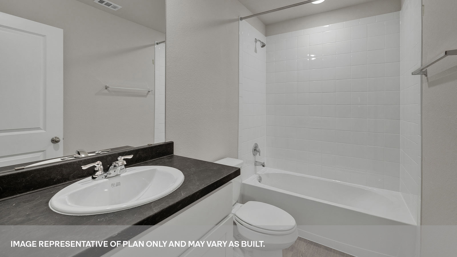 Bathroom 2 with shower and tub, toilet and a single sink vanity.