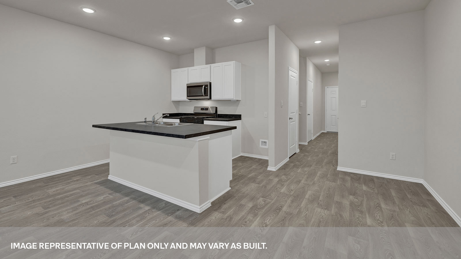 Kitchen with kitchen island with white cabinets and entry hallway.