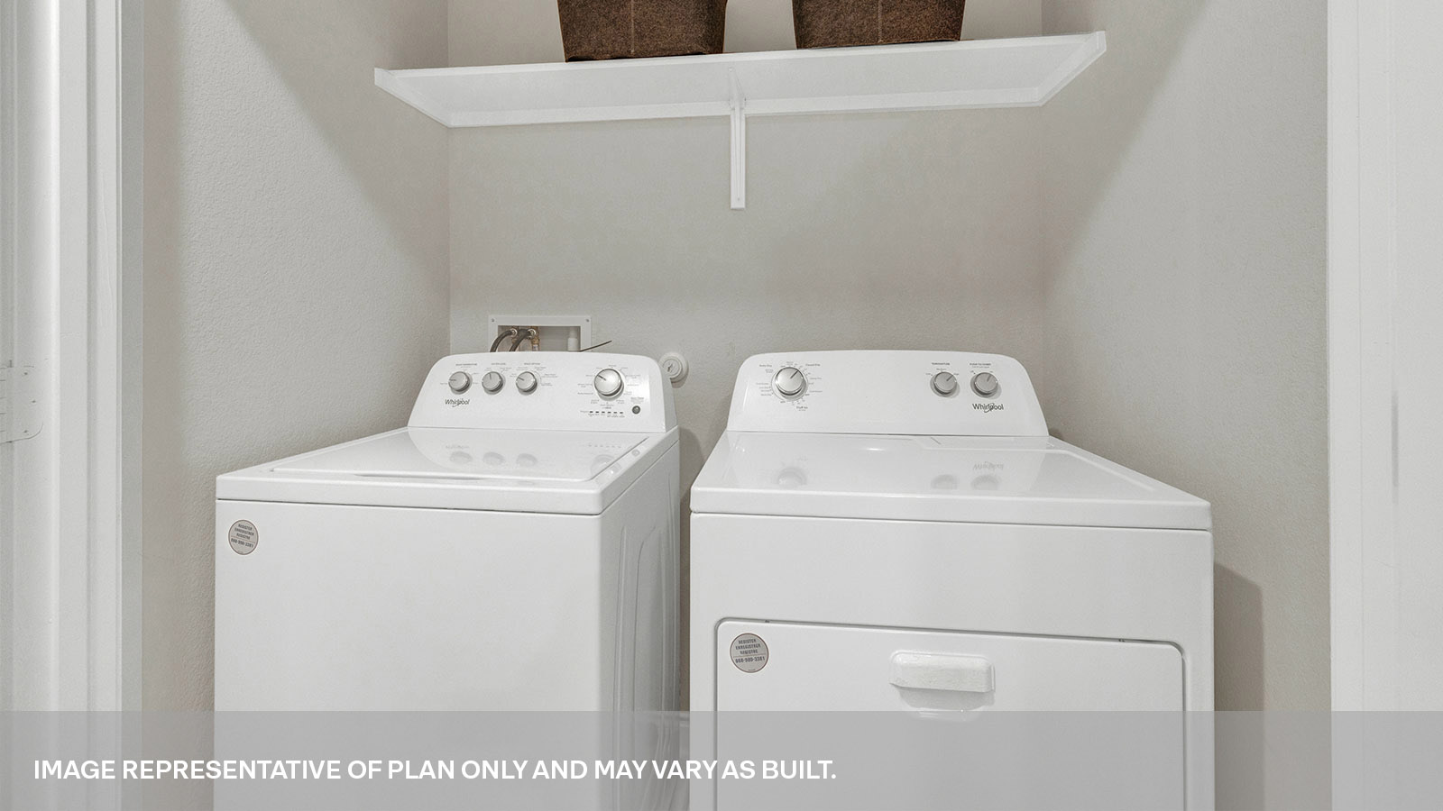 Laundry room with a wood shelf and washer/dryer connections.