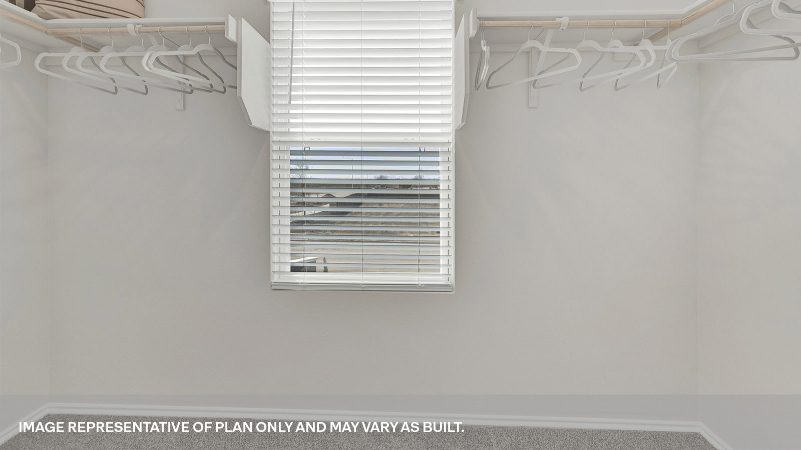 Large walk-in closet with wooden shelves and window.