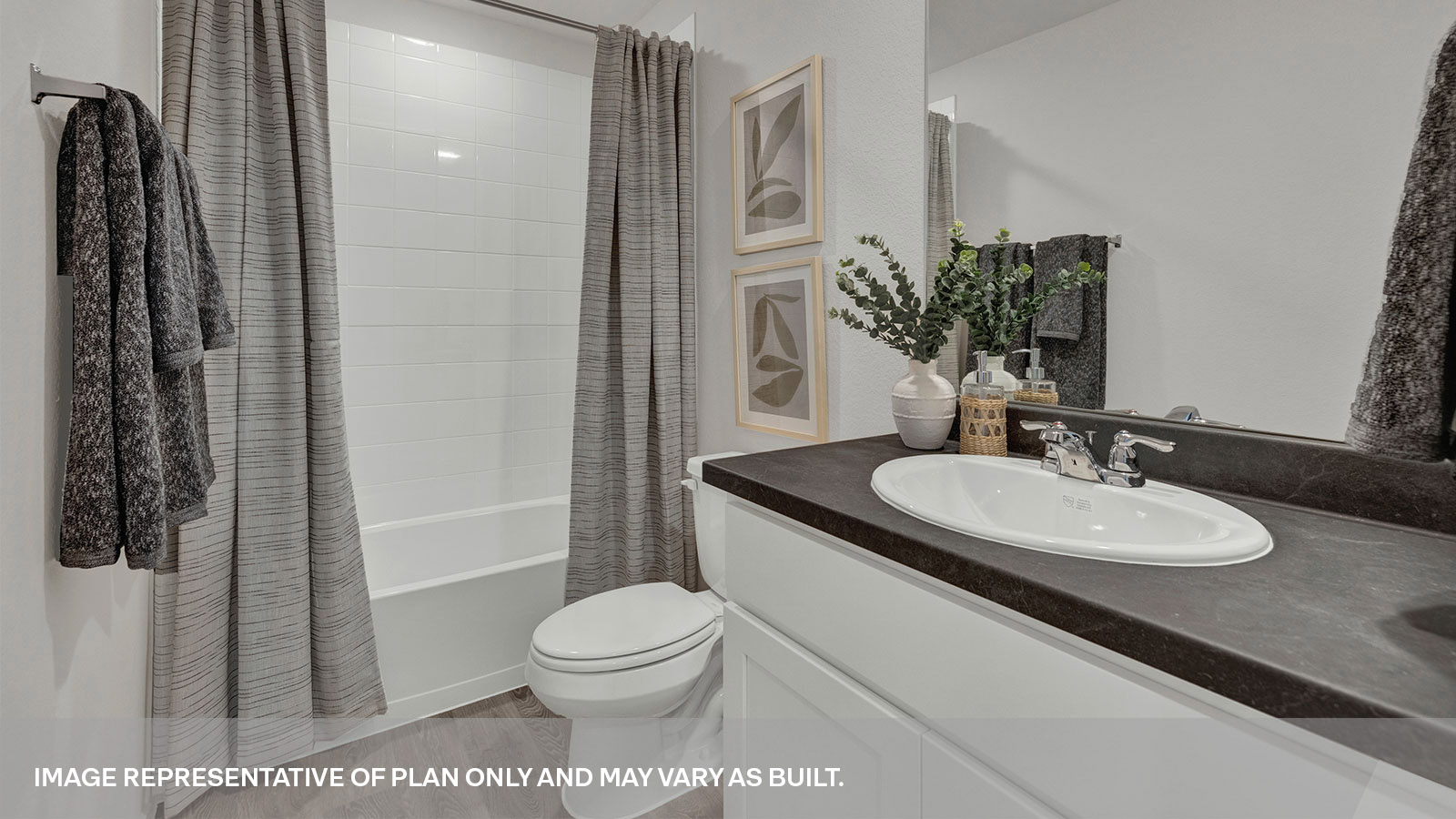 Bathroom 2 with shower and tub, toilet and a single sink vanity.
