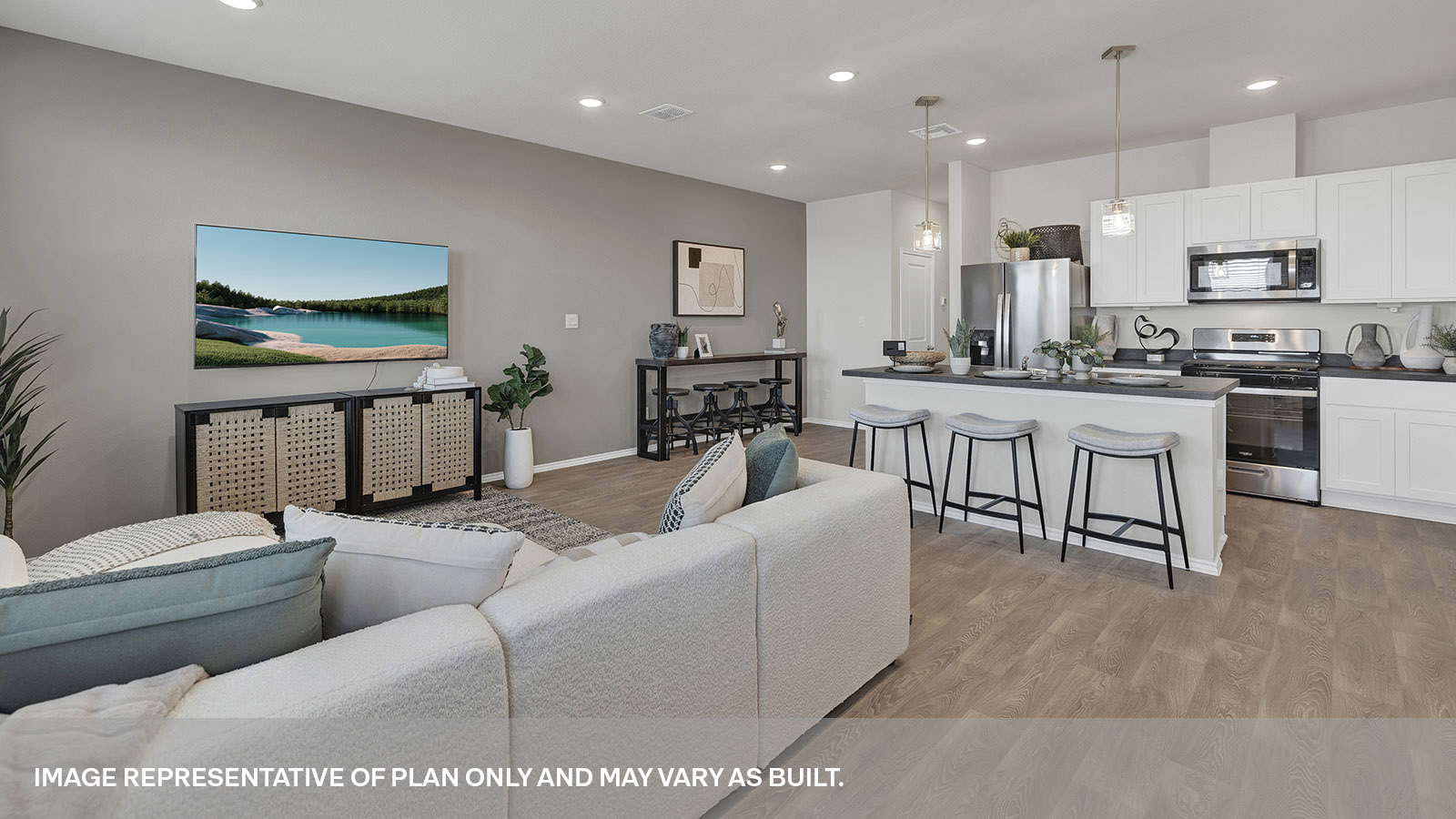 Dining area overlooking the living room, kitchen island, 3 windows and backdoor with a half-lite window.