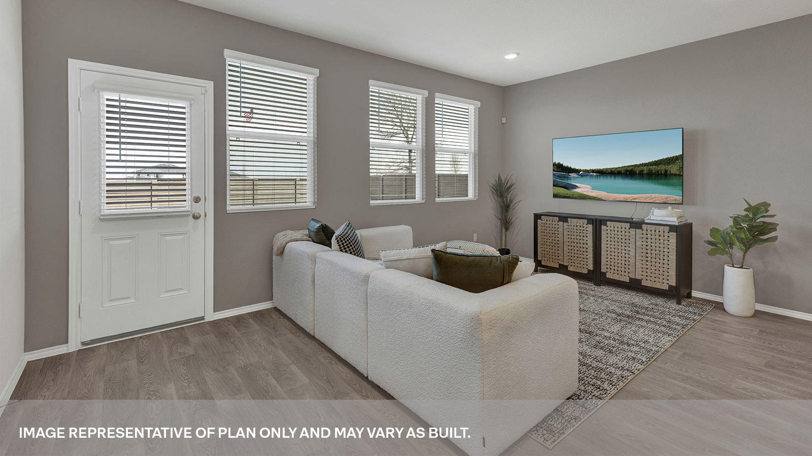 Living area with 3 windows and backdoor with a half-lite window.