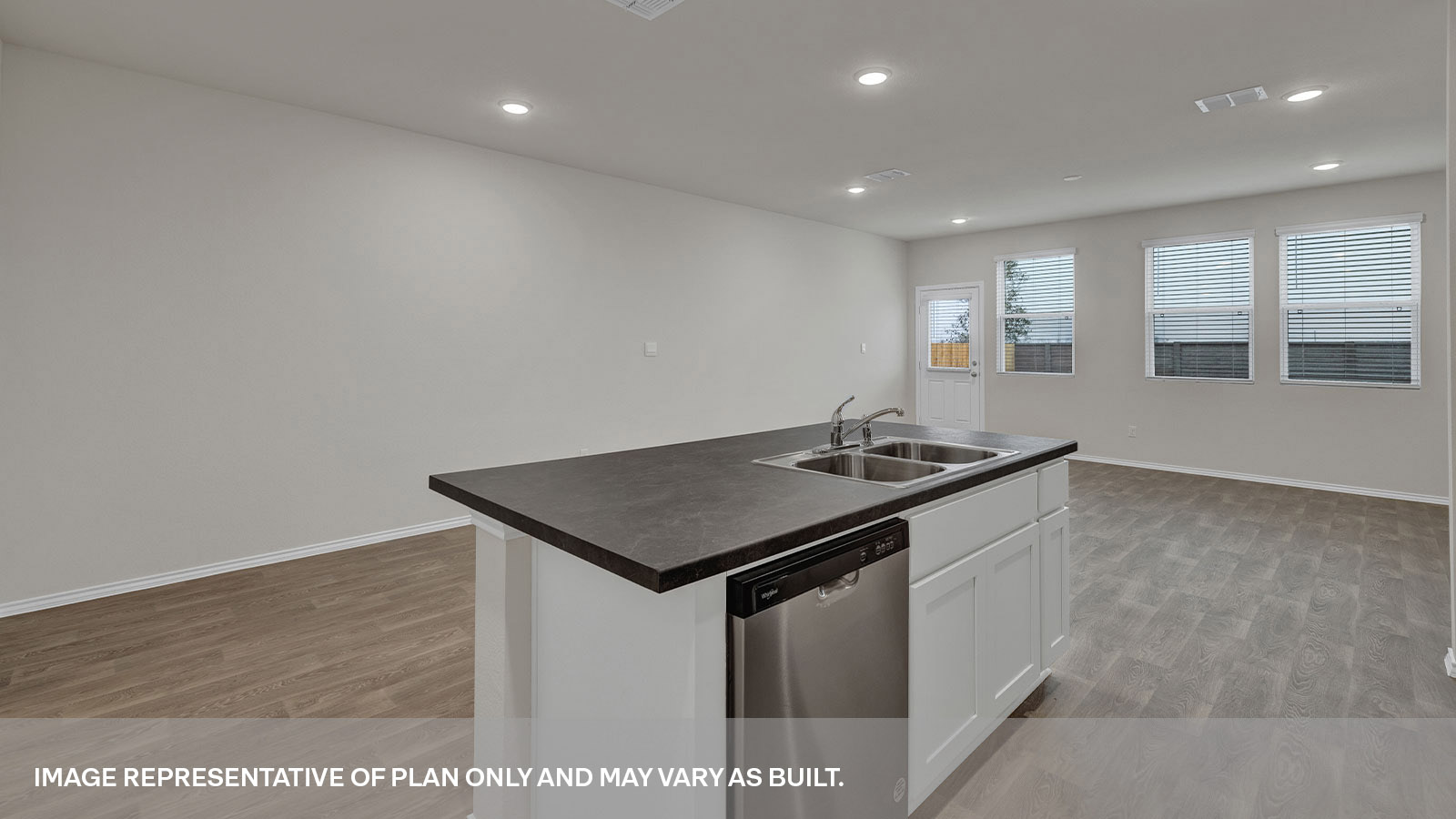Kitchen overlooking the living room, dining area, 3 windows and backdoor with a half-lite window.