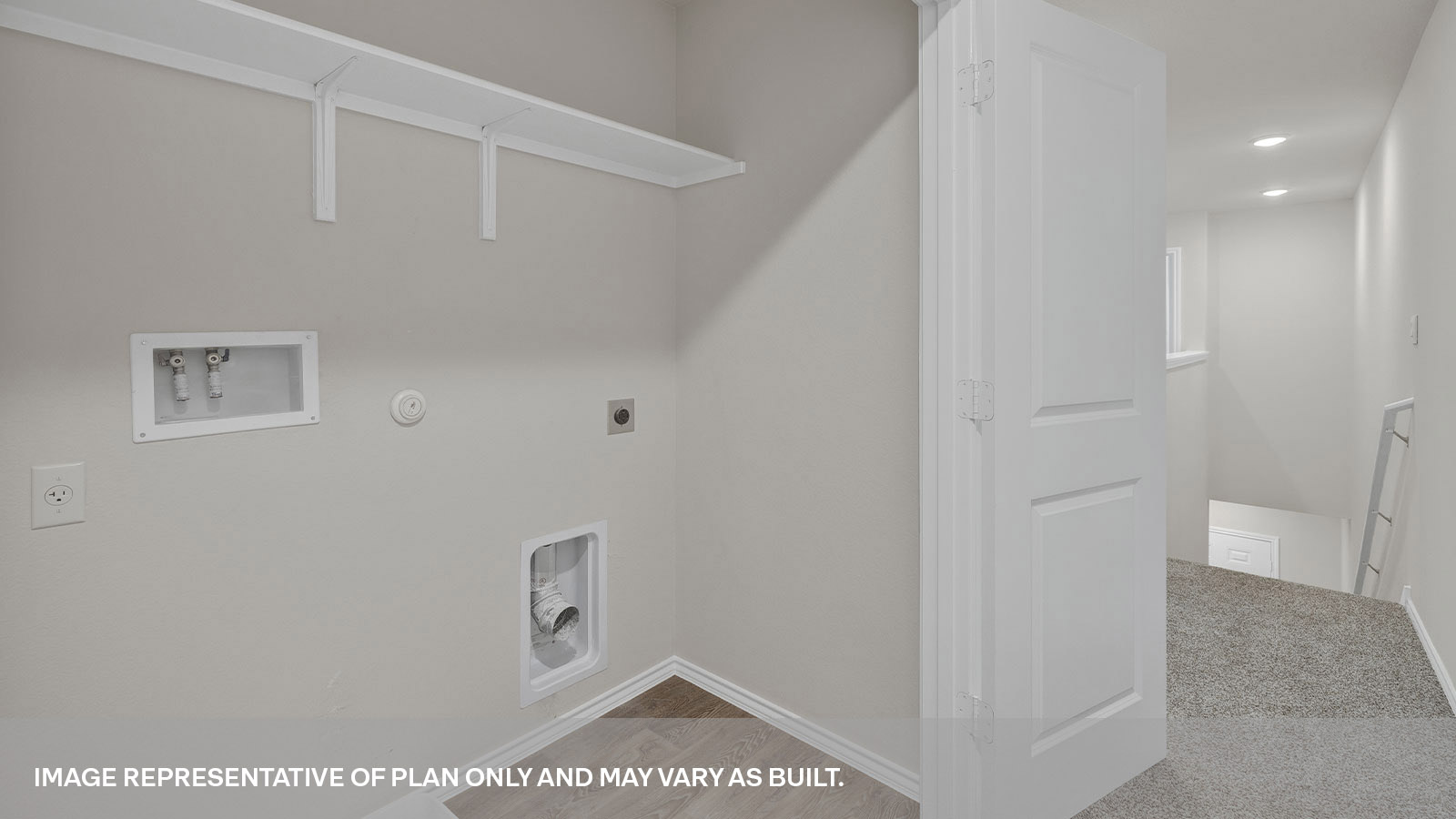 Laundry room with a wood shelf and washer/dryer connections.