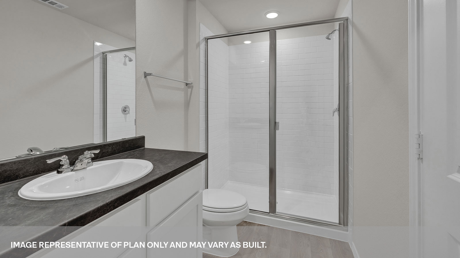 Main bathroom with large walk-in shower with glass door, toilet and a single sink vanity.