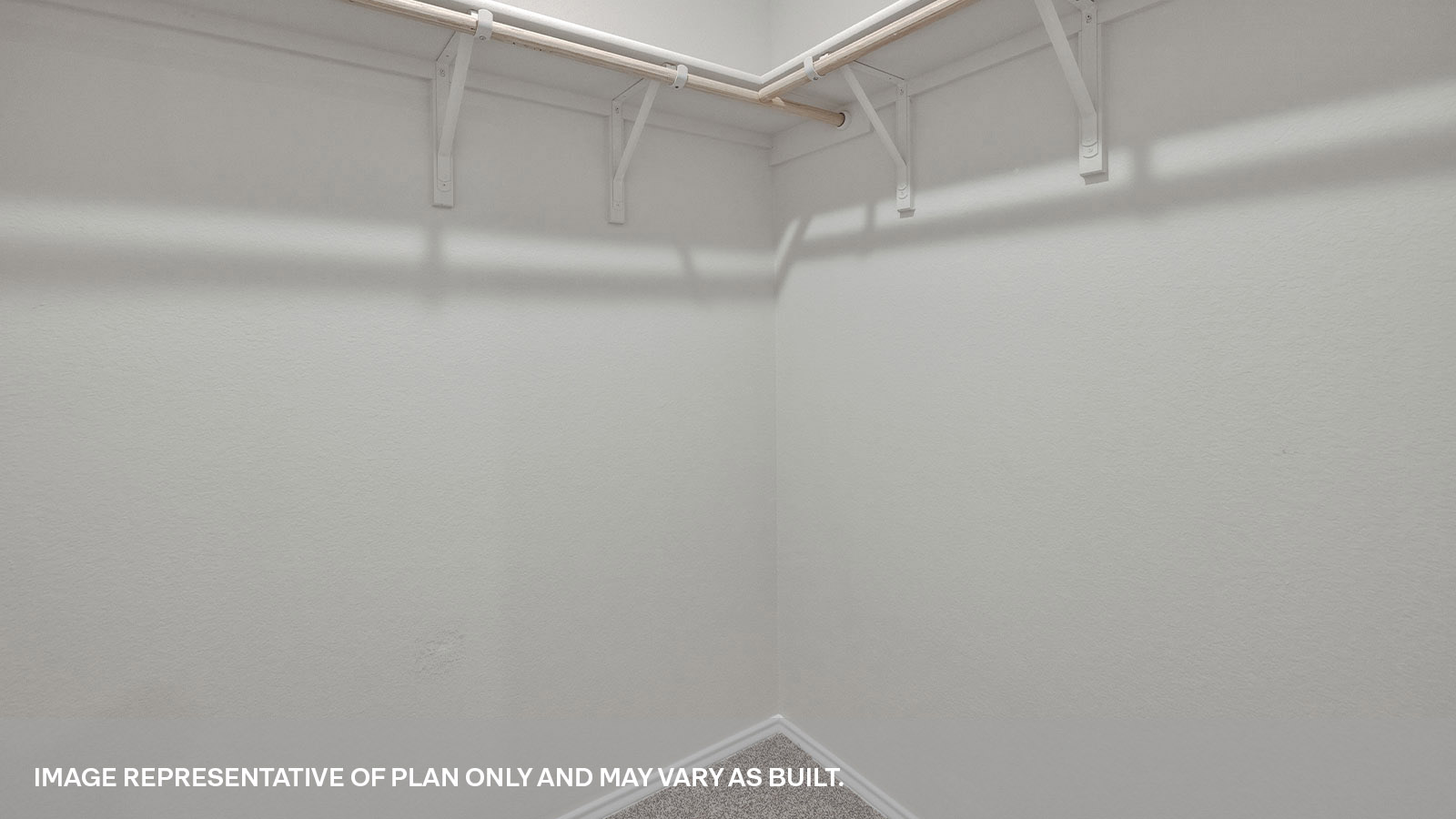 Large walk-in closet with wooden shelves.