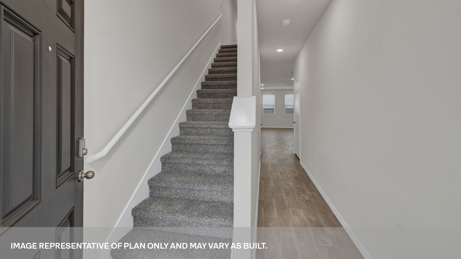 Entry hallway with vinyl flooring and a staircase leading towards the second floor.