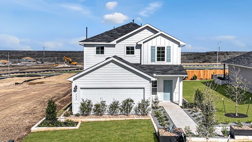 two story farmhouse home with blue shutters