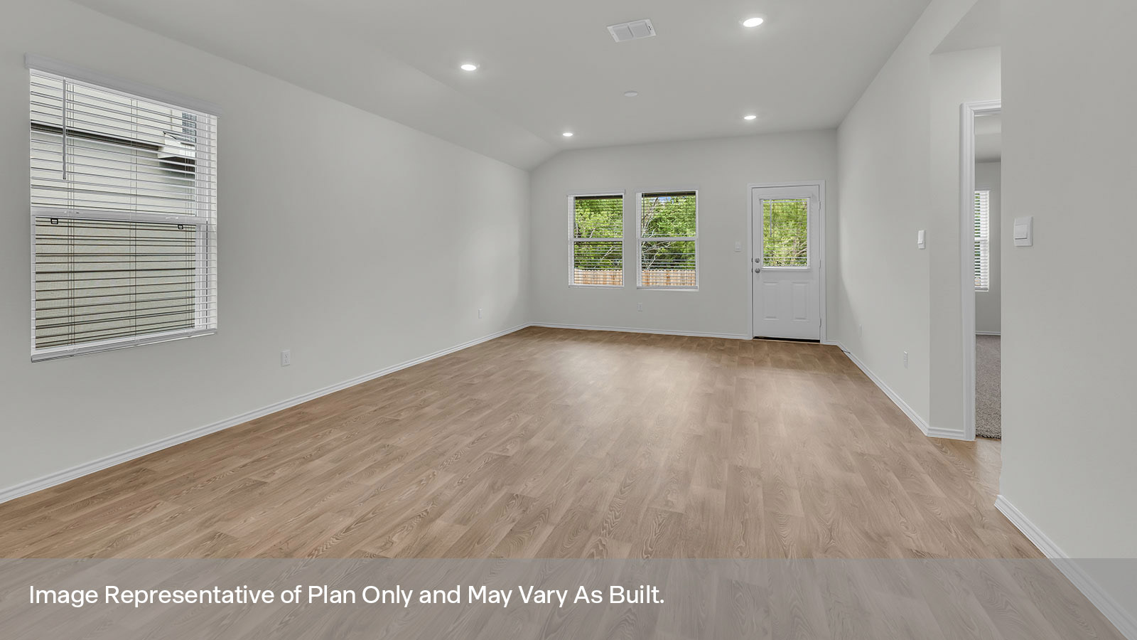 Dining room and living room with vinyl flooring, windows, and an exterior door leading to the backyard.