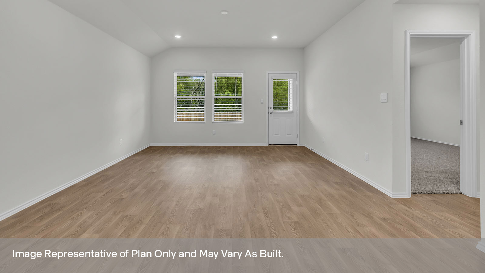 Living room with vinyl flooring, windows, and a half lite exterior door.