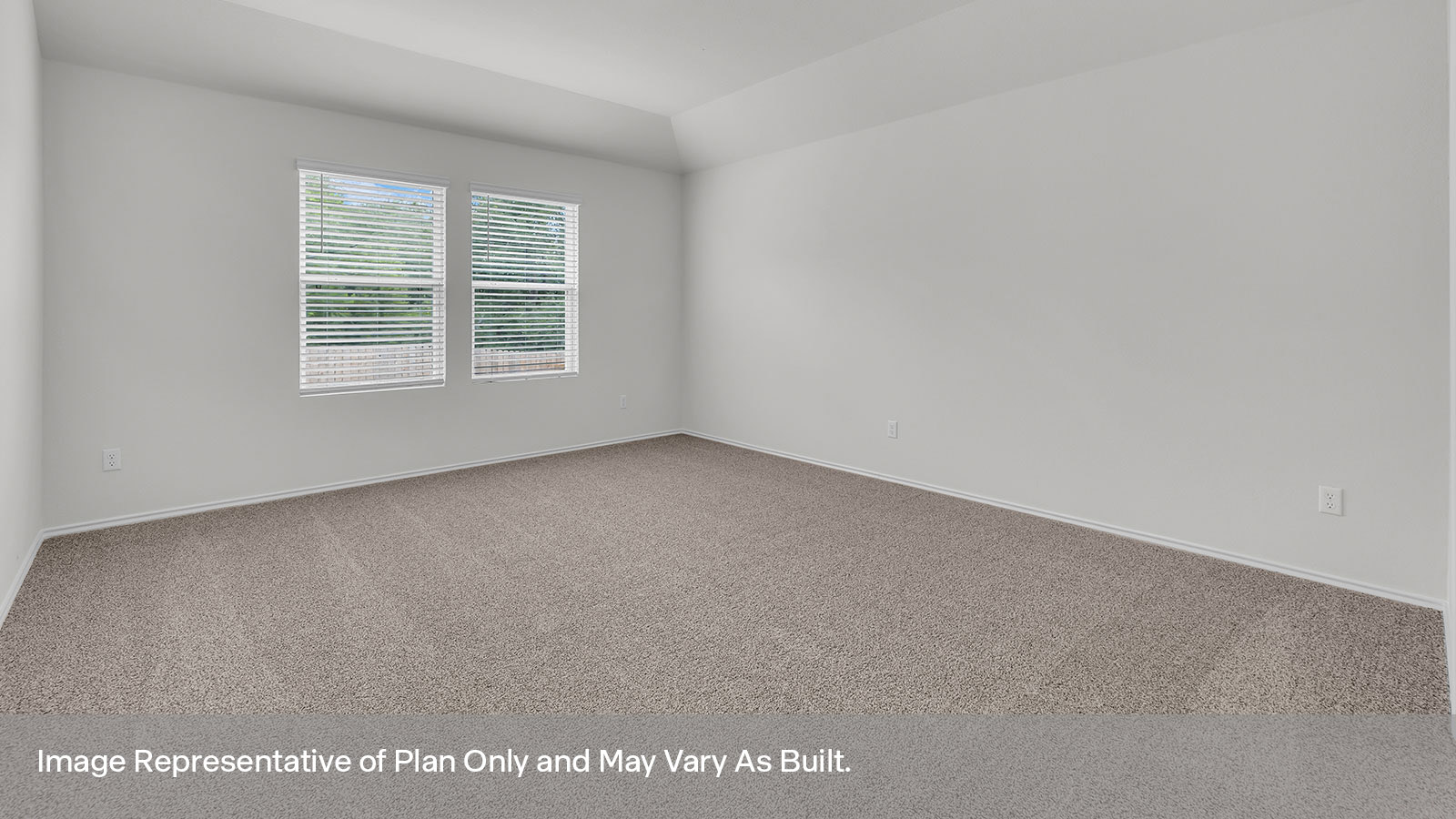 Main bedroom with carpeting and two windows.
