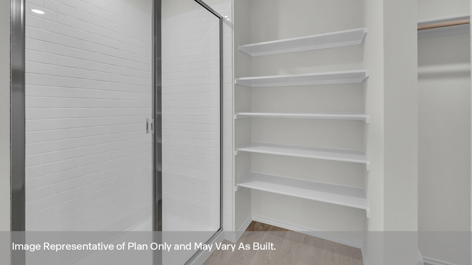 Main bathroom stand in shower with shower glass door and wooden shelving.