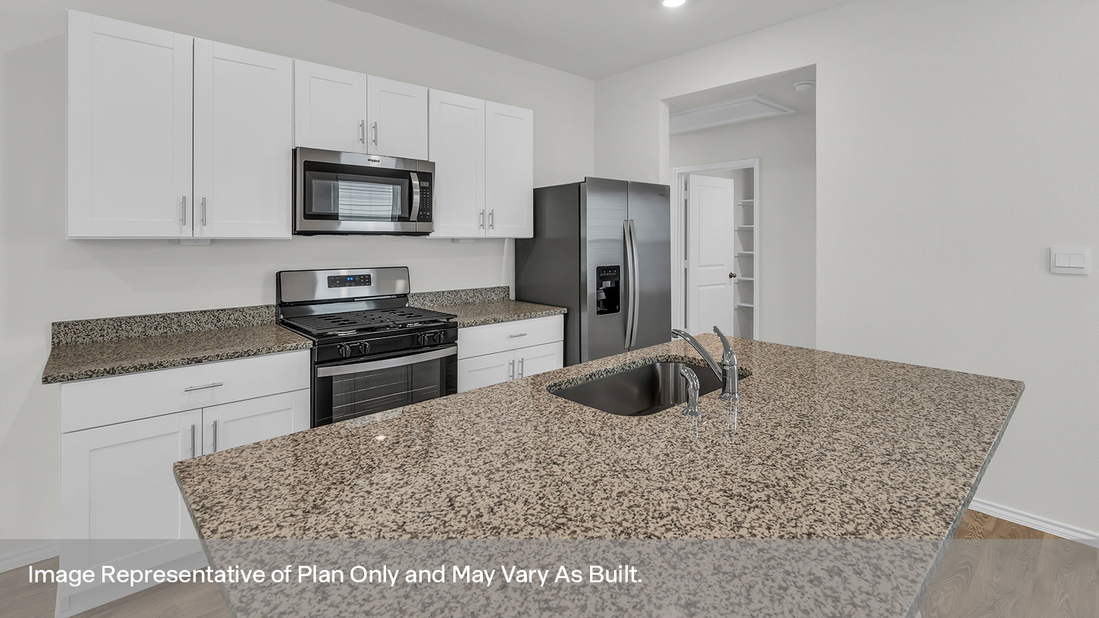 Kitchen with kitchen island, granite countertops, and stainless steel appliances.