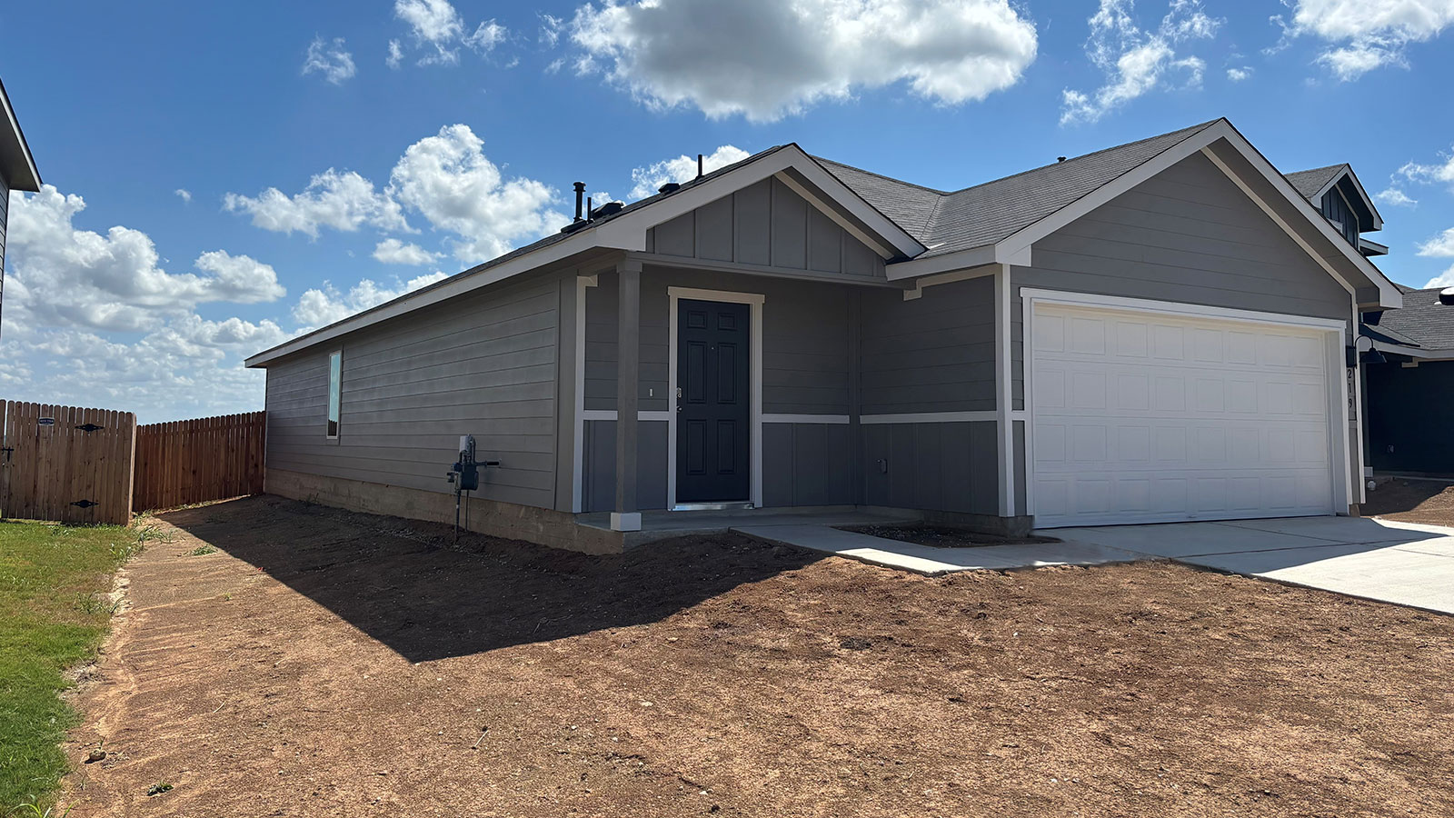 farmhouse single story home with 2 car garage
