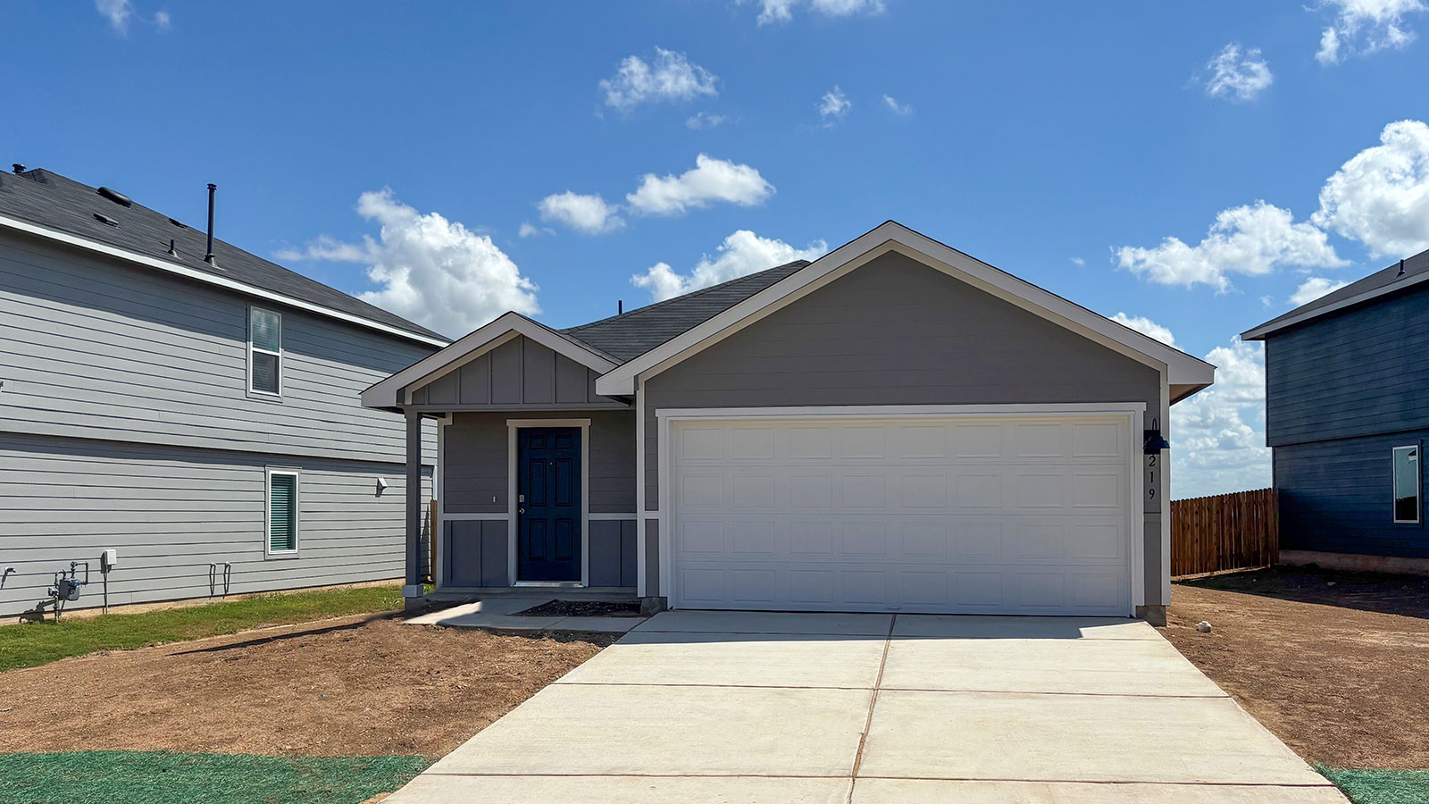 farmhouse single story home with 2 car garage