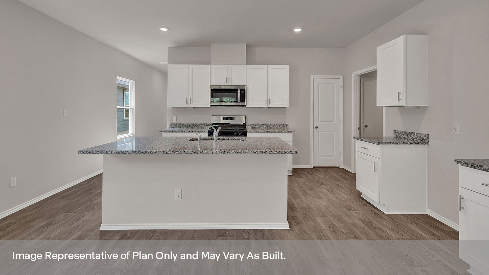 Kitchen with kitchen island and white cabinets.