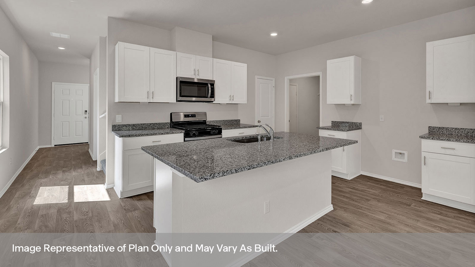Entry hallway leading to the kitchen with kitchen island.