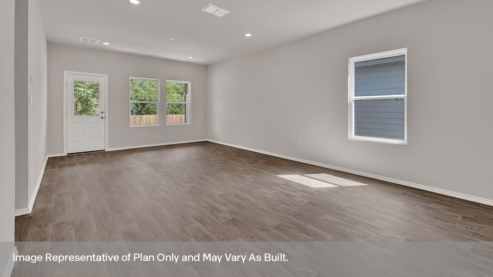 Dining room opening to the living room with vinyl flooring, windows, and a half lite exterior door.