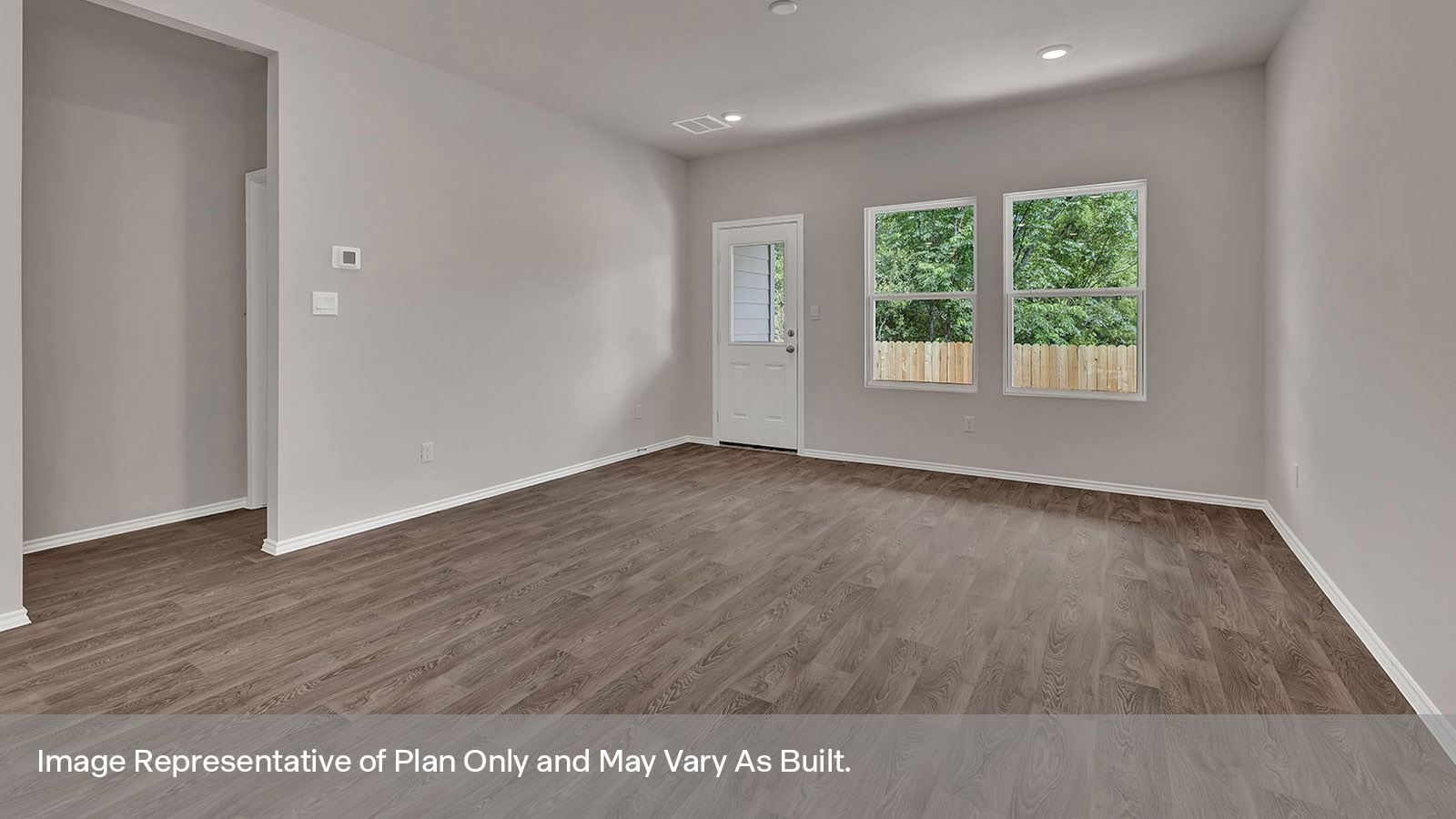 Living room with vinyl flooring, windows, and an exterior door opening to the backyard.