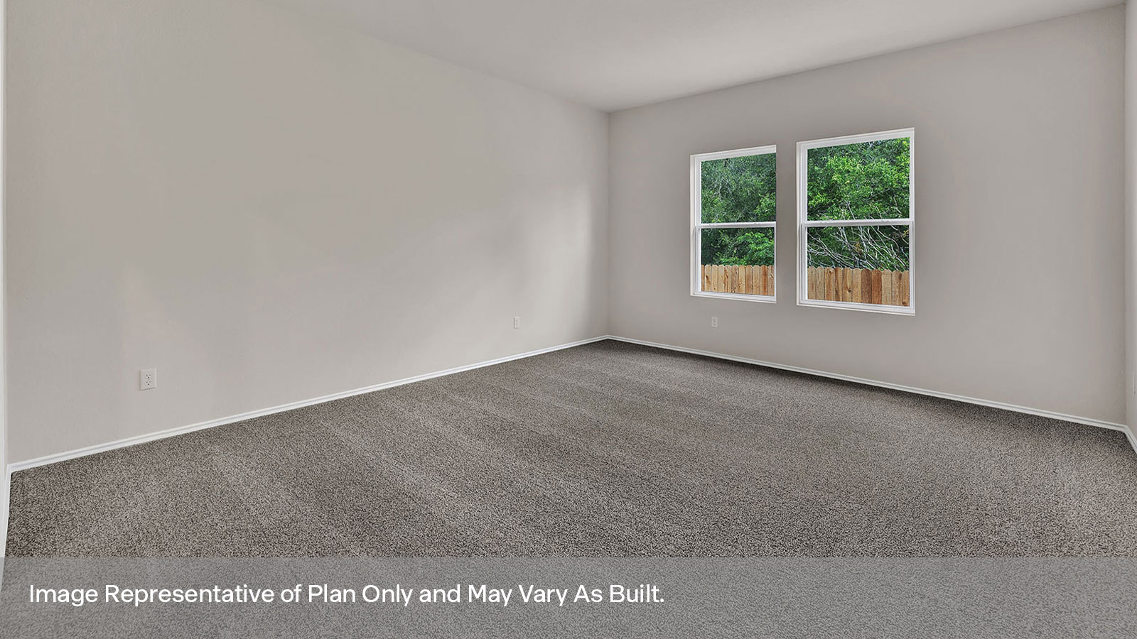 Main bedroom with carpeting and two windows.