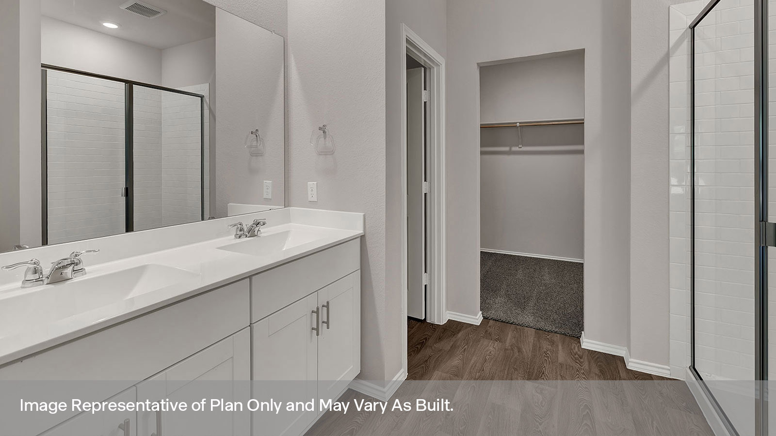 Main bathroom with double sink vanity, shower, and water closet.