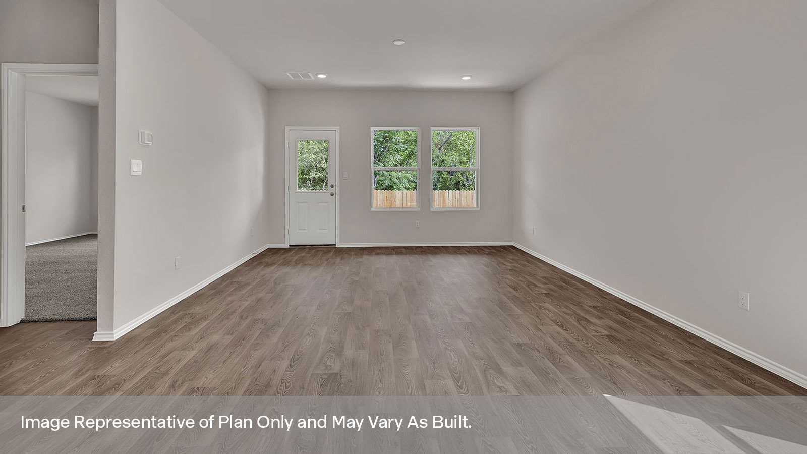 Dining room and living room with windows and an exterior door.