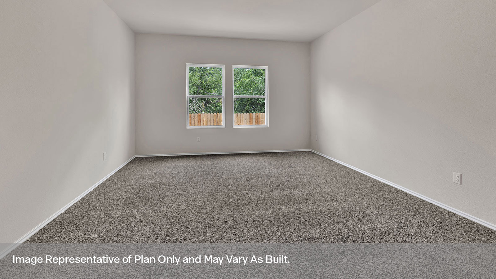 Main bedroom with carpeting and two windows.