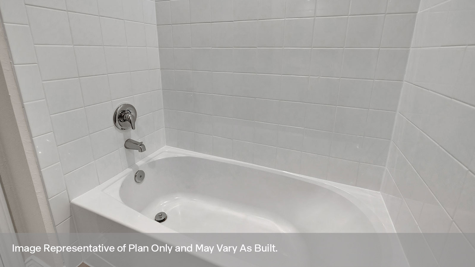 Hall bathroom tub with tile surround.