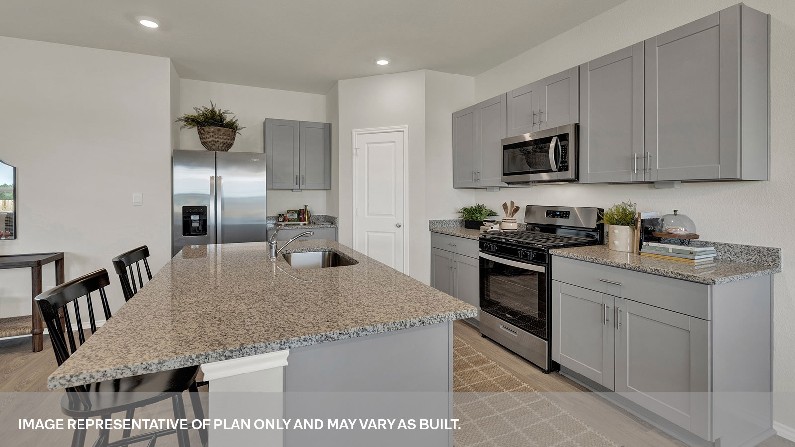 Kitchen with kitchen island and grey cabinets.