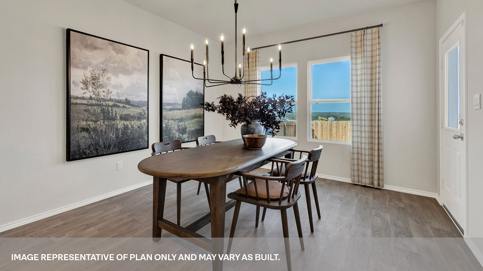 Dining room with vinyl flooring and two windows.