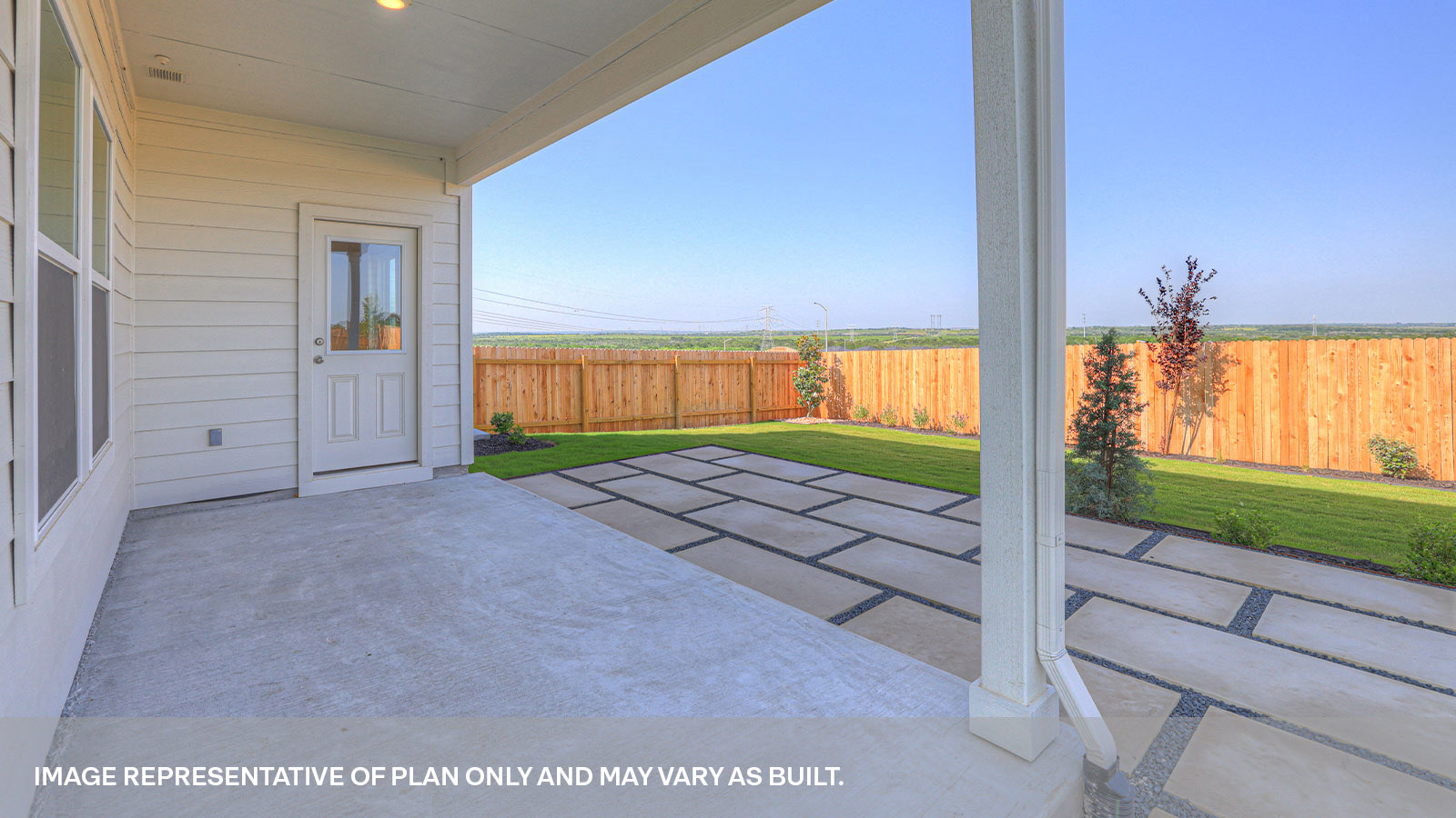 Covered patio with two windows and a half lite exterior door.